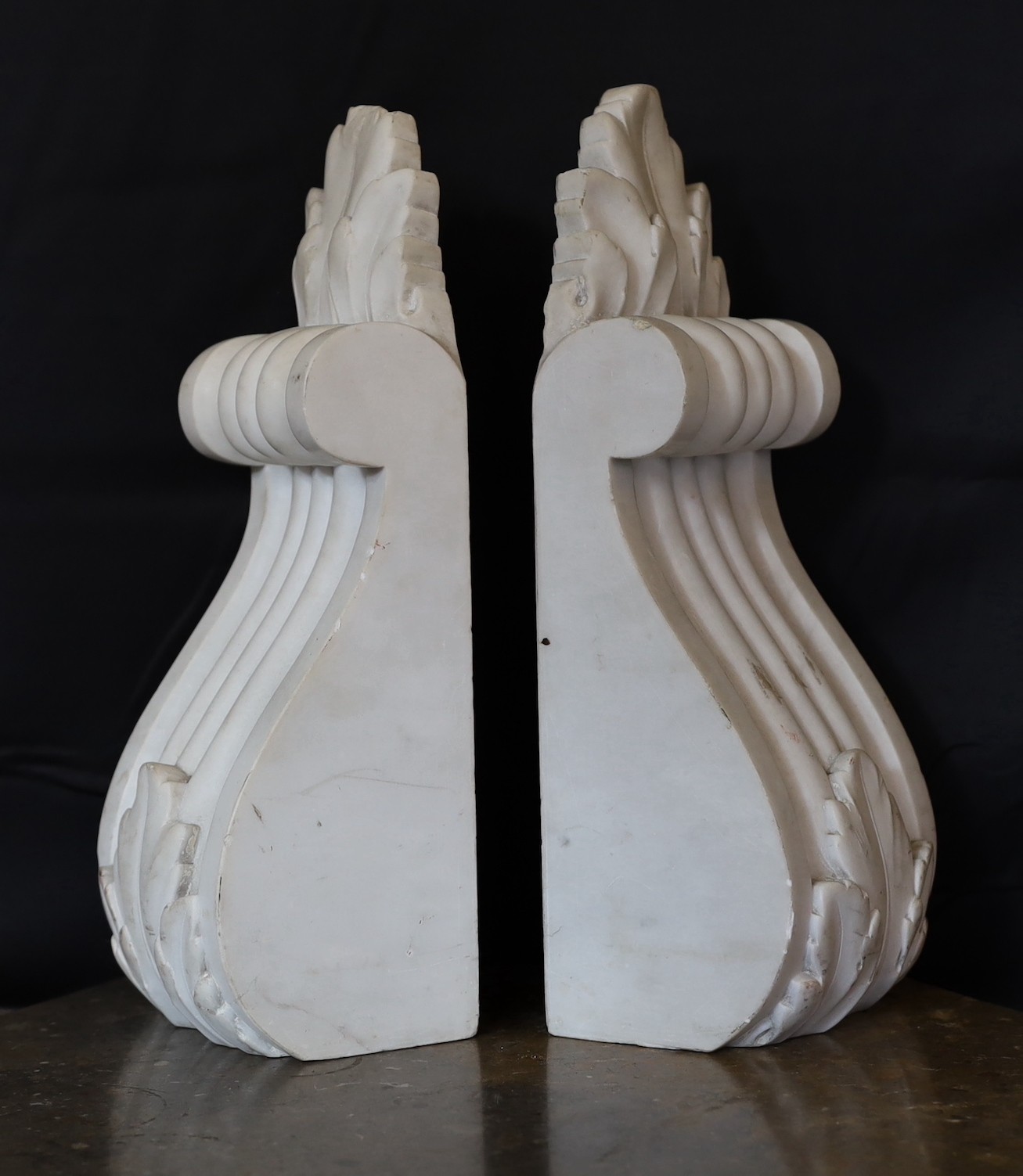 A pair of Victorian cast iron corbels and a pair of carved white marble corbels, height 26cm & 35cm